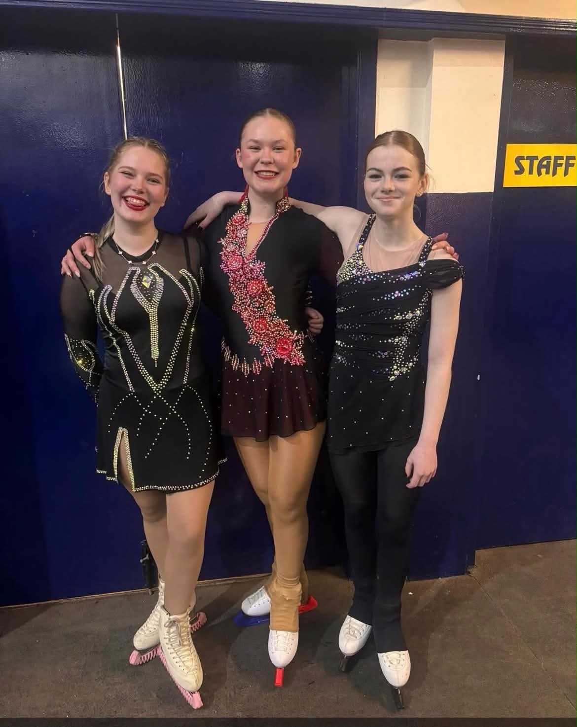Three GFSK skaters together after performing